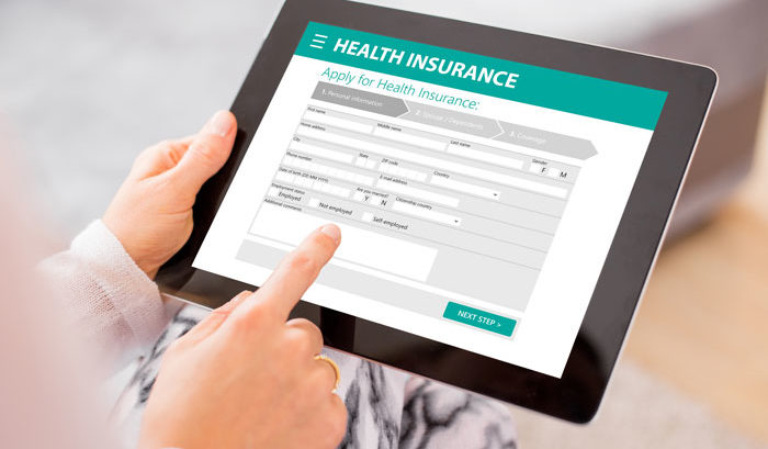 person signing up for health insurance on tablet