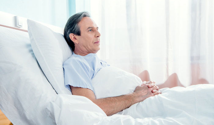 man in hospital bed contemplating future
