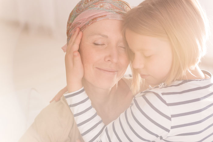 female cancer patient hugging daughter