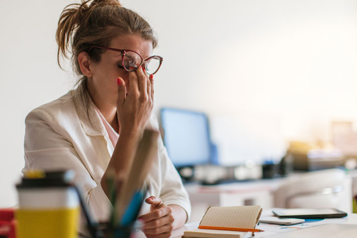young female professional stressed at work
