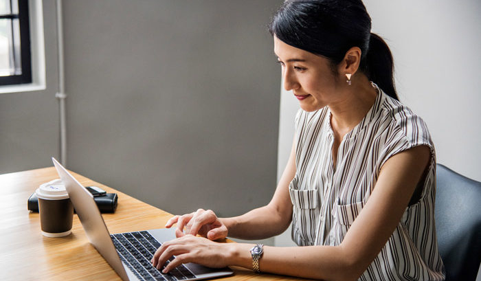 woman online shopping on laptop for dental insurance