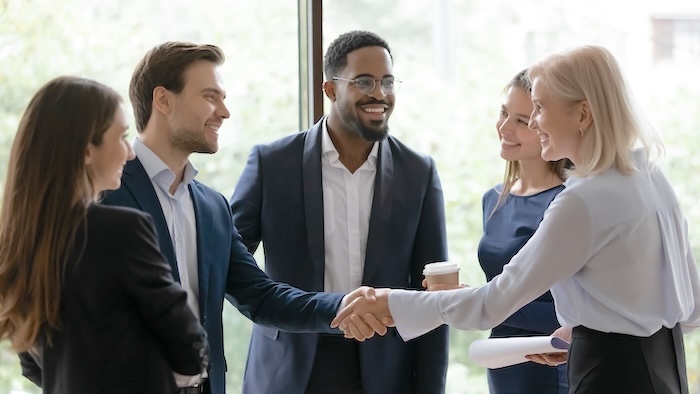 Office workers shaking hands